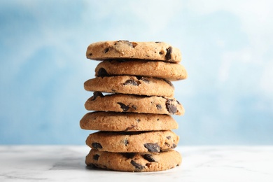 Photo of Stack of tasty chocolate chip cookies on table