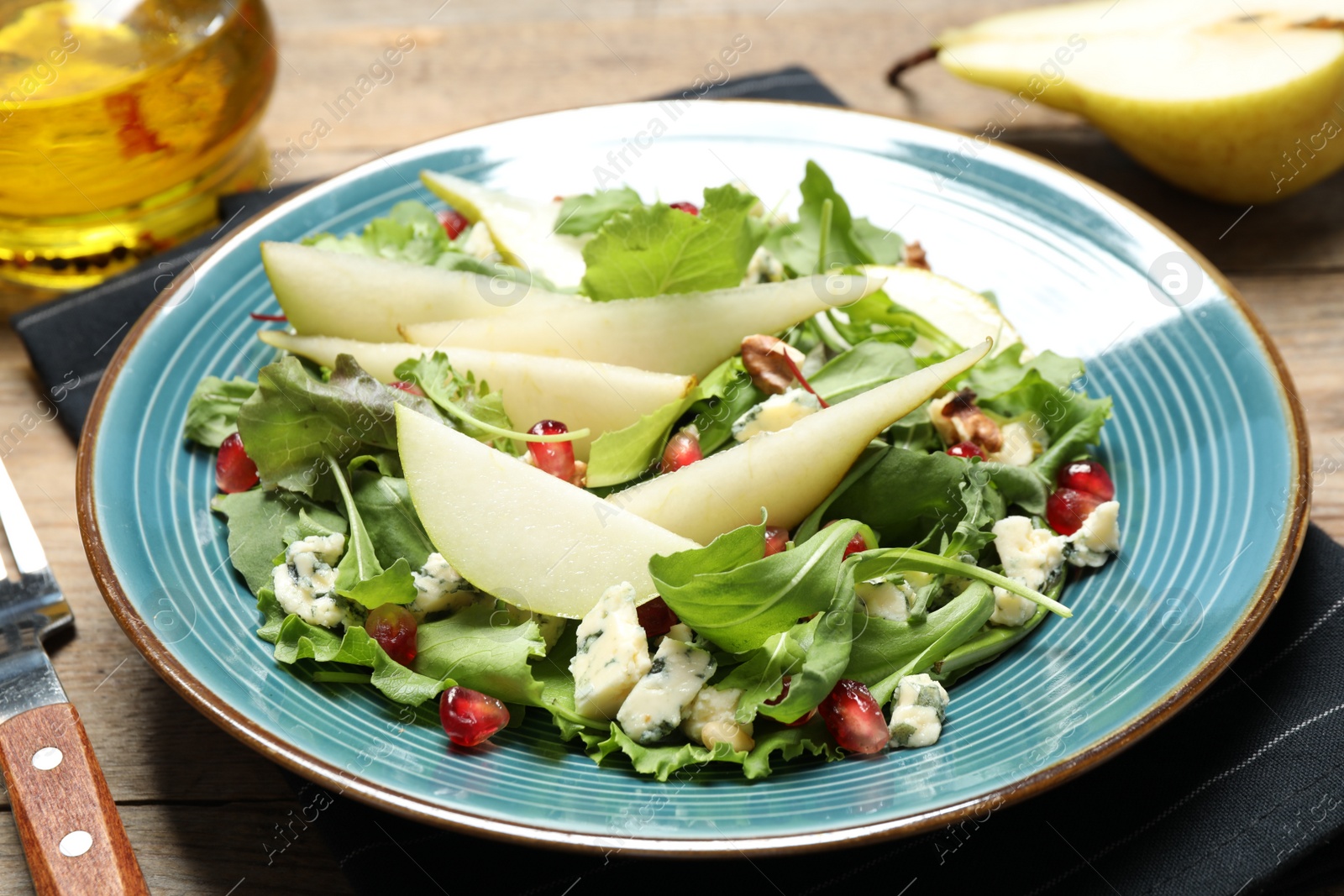 Photo of Fresh salad with pear served on wooden table