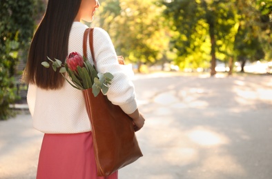 Photo of Woman with leather shopper bag in park, closeup