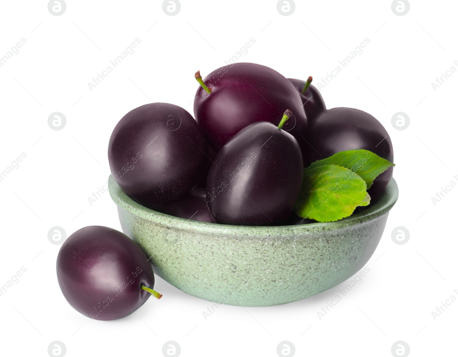 Photo of Bowl of delicious ripe plums on white background