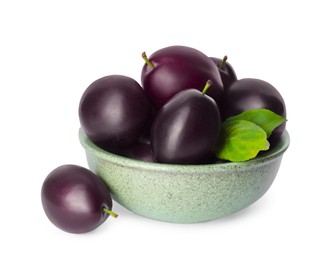 Bowl of delicious ripe plums on white background
