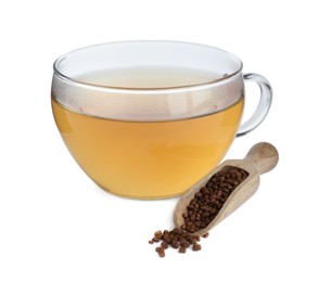 Glass cup of buckwheat tea and granules on white background