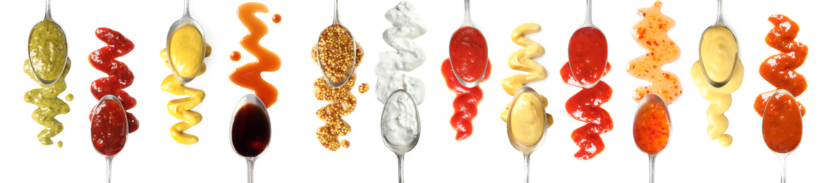 Image of Set of spoons with different delicious sauces on white background, top view. Banner design