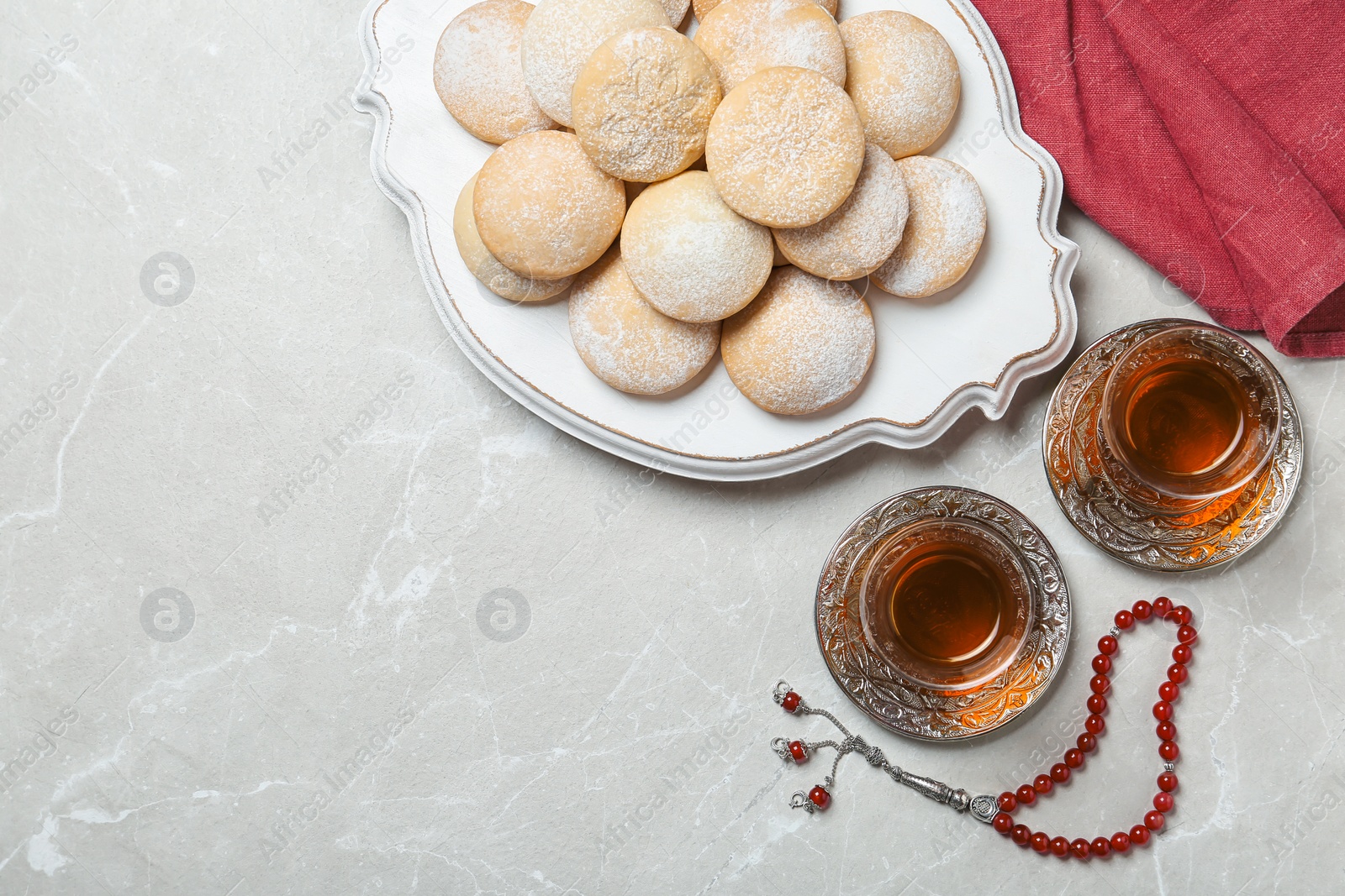Photo of Flat lay composition with traditional Islamic cookies on table, space for text. Eid Mubarak