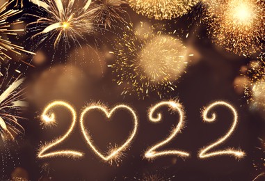 Image of Happy New Year greeting card design. 2022 silhouettes made of fireworks 