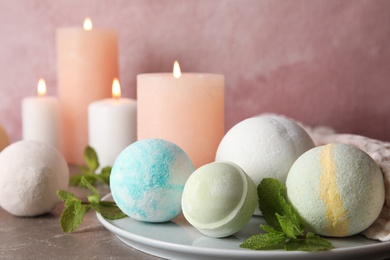 White plate with bath bombs and mint leaves on table