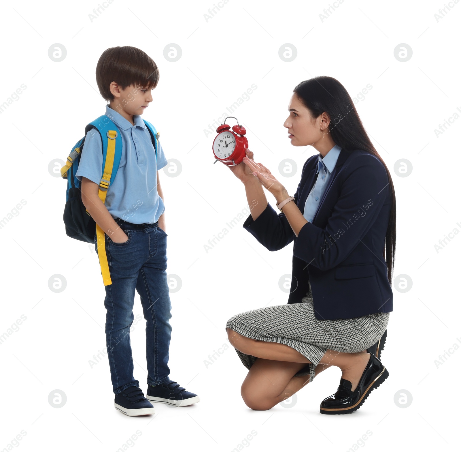 Photo of Teacher with alarm clock scolding pupil for being late against white background