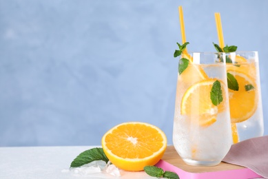 Photo of Delicious refreshing drink on white table. Space for text