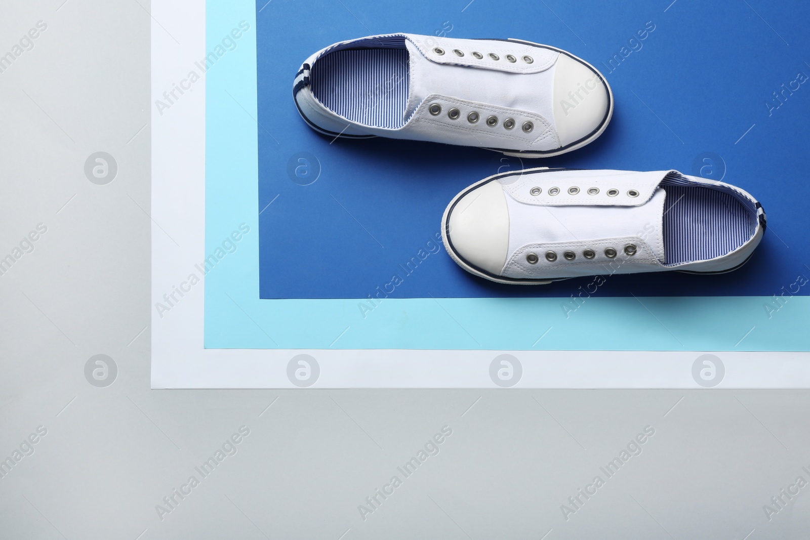 Photo of Stylish sneakers on color background, top view with space for text