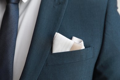 Man with handkerchief in suit pocket, closeup view