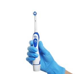 Photo of Dentist holding electric toothbrush on white background