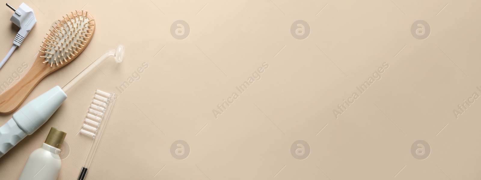 Image of Flat lay composition with high frequency darsonval device on beige background, space for text. Banner design