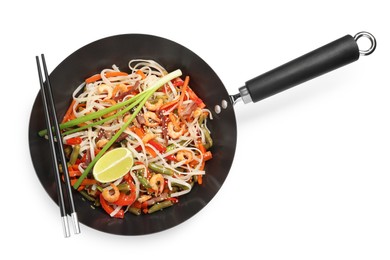 Photo of Shrimp stir fry with noodles and vegetables in wok isolated on white, top view