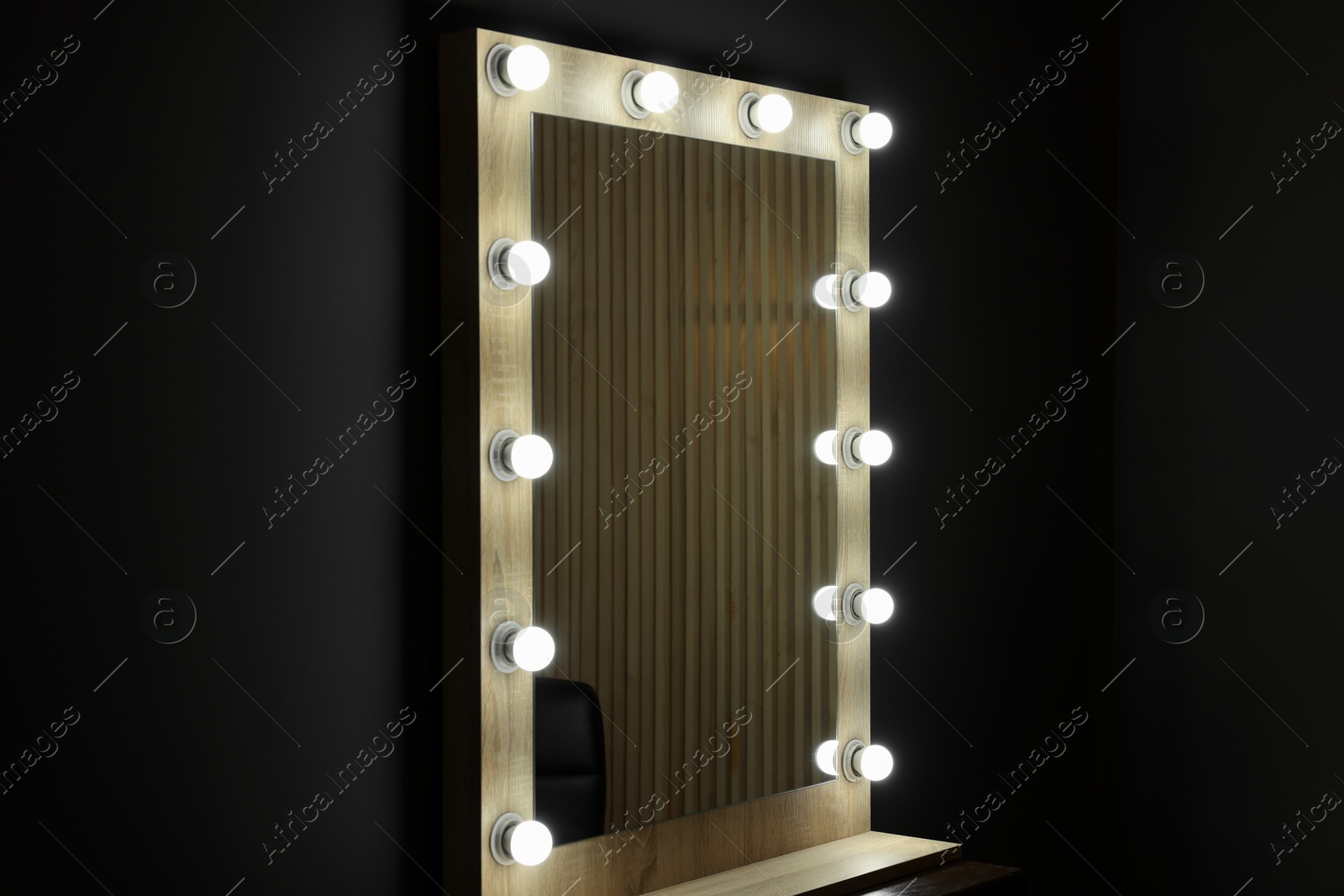 Photo of Beautiful mirror with light bulbs in makeup room