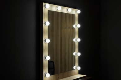 Photo of Beautiful mirror with light bulbs in makeup room