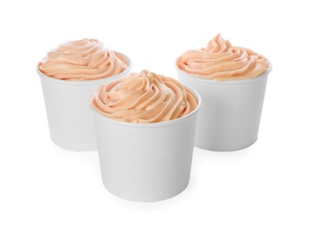 Cups with tasty frozen yogurt on white background