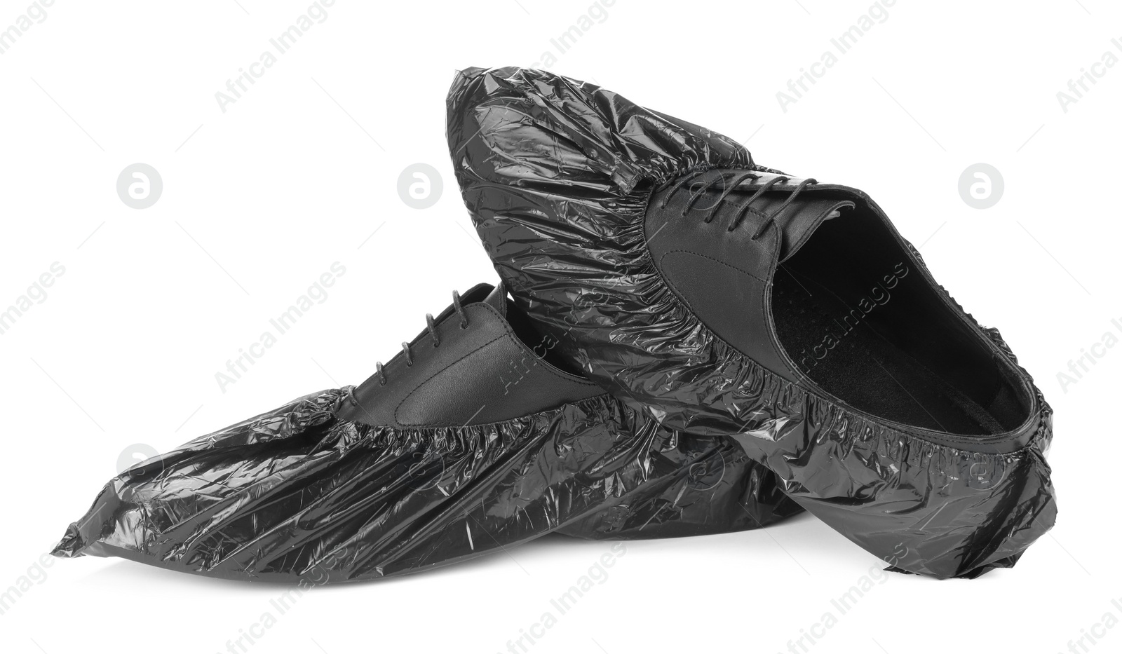 Photo of Men's shoes in black shoe covers isolated on white