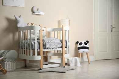 Photo of Cute baby room interior with modern crib and toys