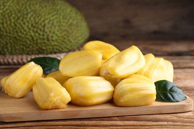 Fresh exotic jackfruit bulbs on wooden table