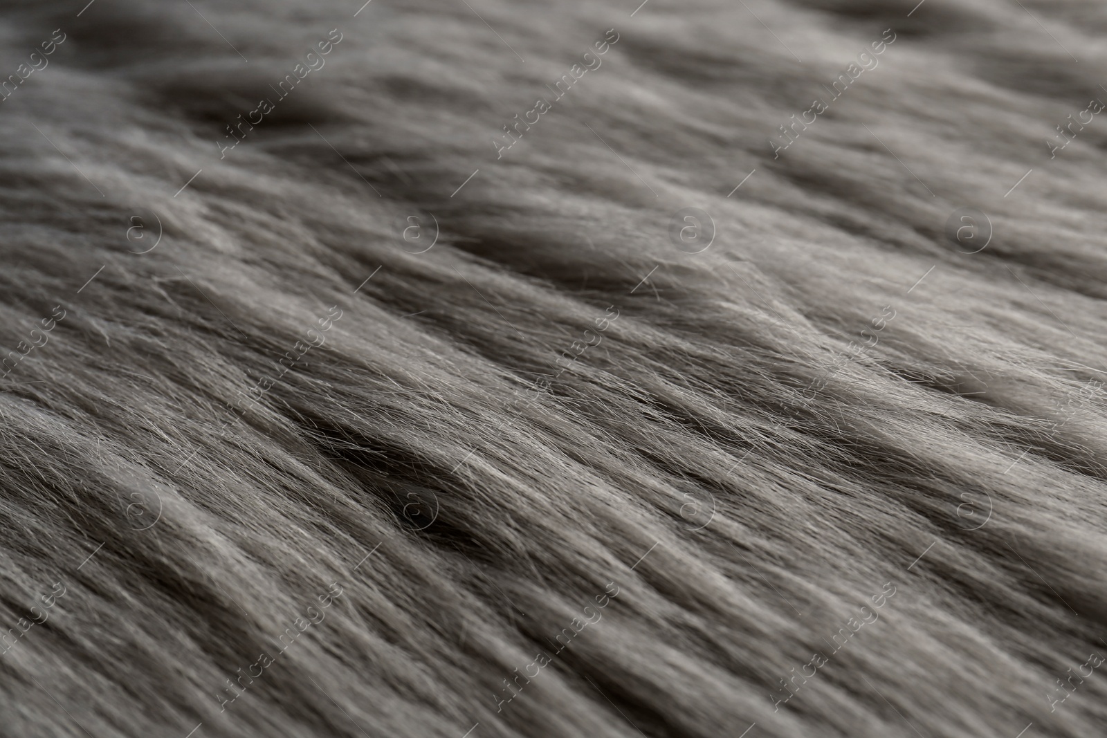 Photo of Beautiful grey faux fur as background, closeup view