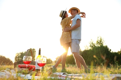 Happy couple hugging on picnic in park