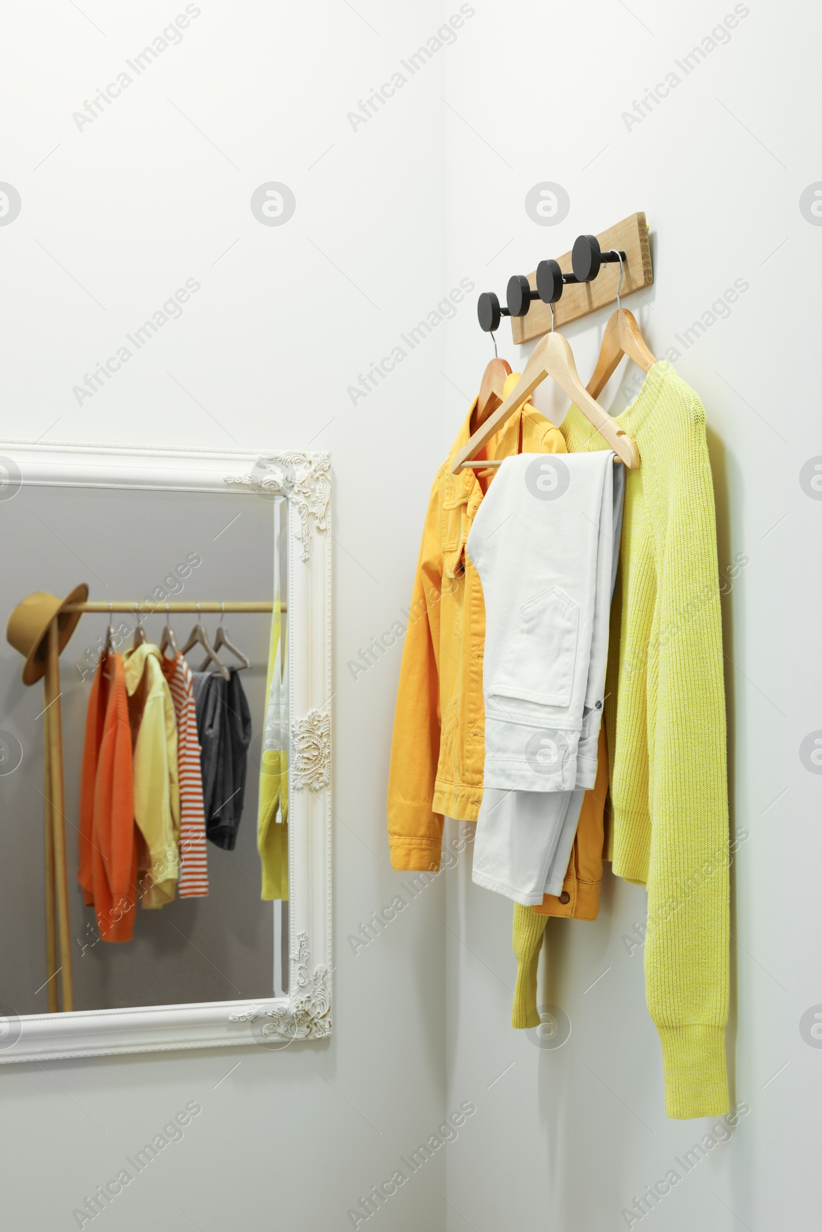 Photo of Dressing room with mirror in fashion store. Stylish design