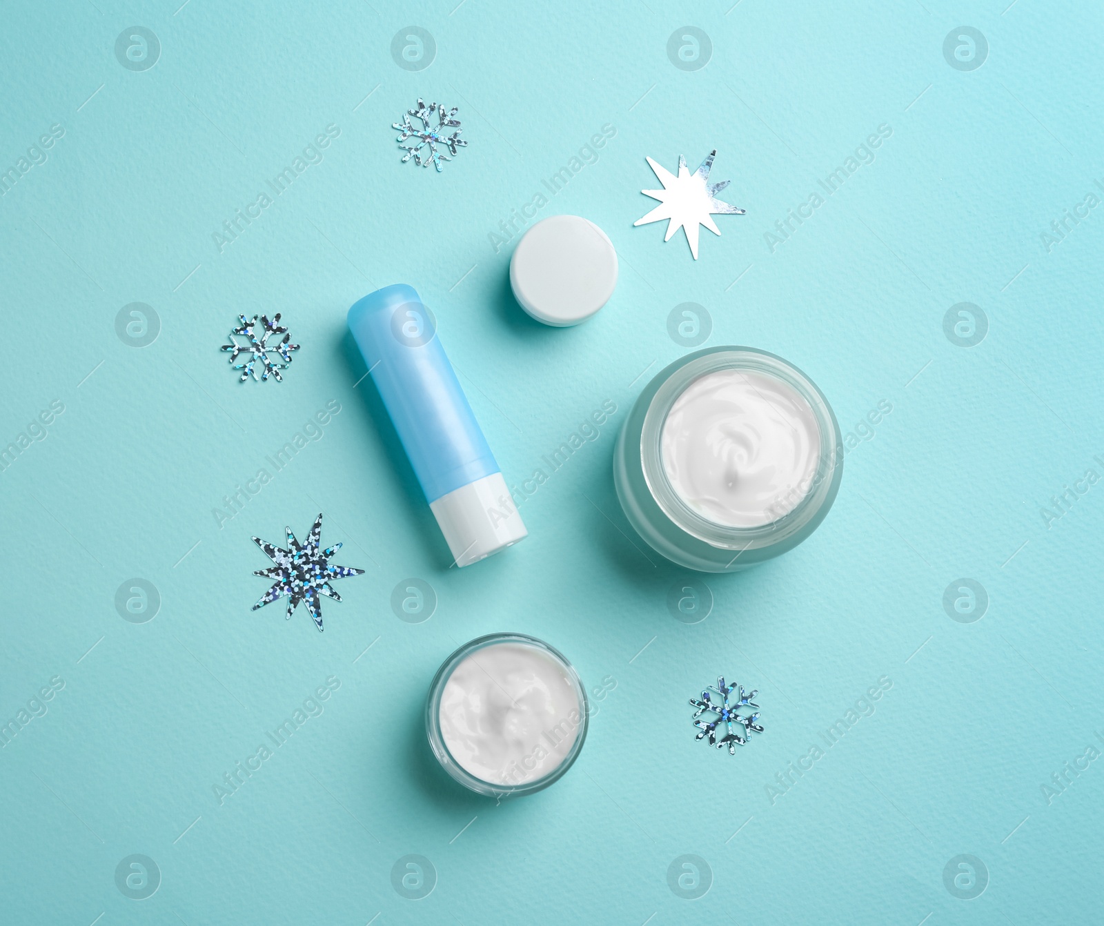 Photo of Flat lay composition with different cosmetic products on turquoise background. Winter care