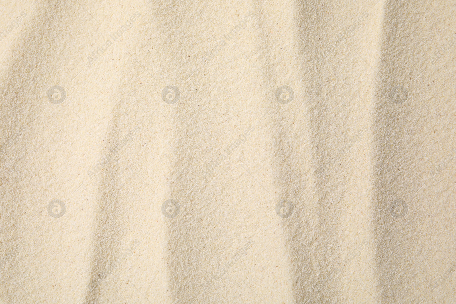 Photo of Uncooked organic semolina as background, top view