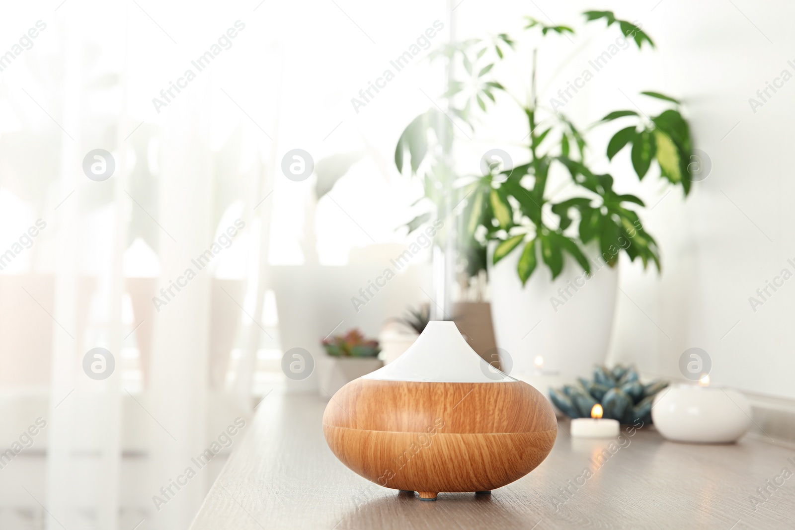 Photo of Composition with modern essential oil diffuser on wooden shelf indoors, space for text