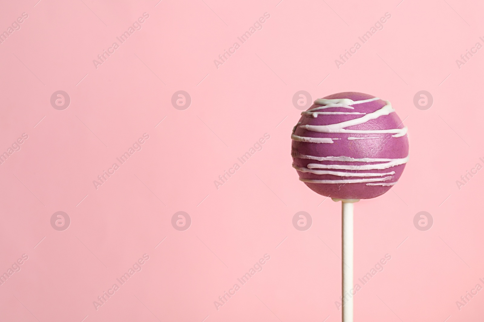 Photo of Bright delicious cake pop on color background. Space for text