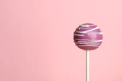 Bright delicious cake pop on color background. Space for text