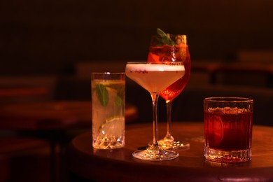 Photo of Fresh alcoholic cocktails on table in bar. Space for text