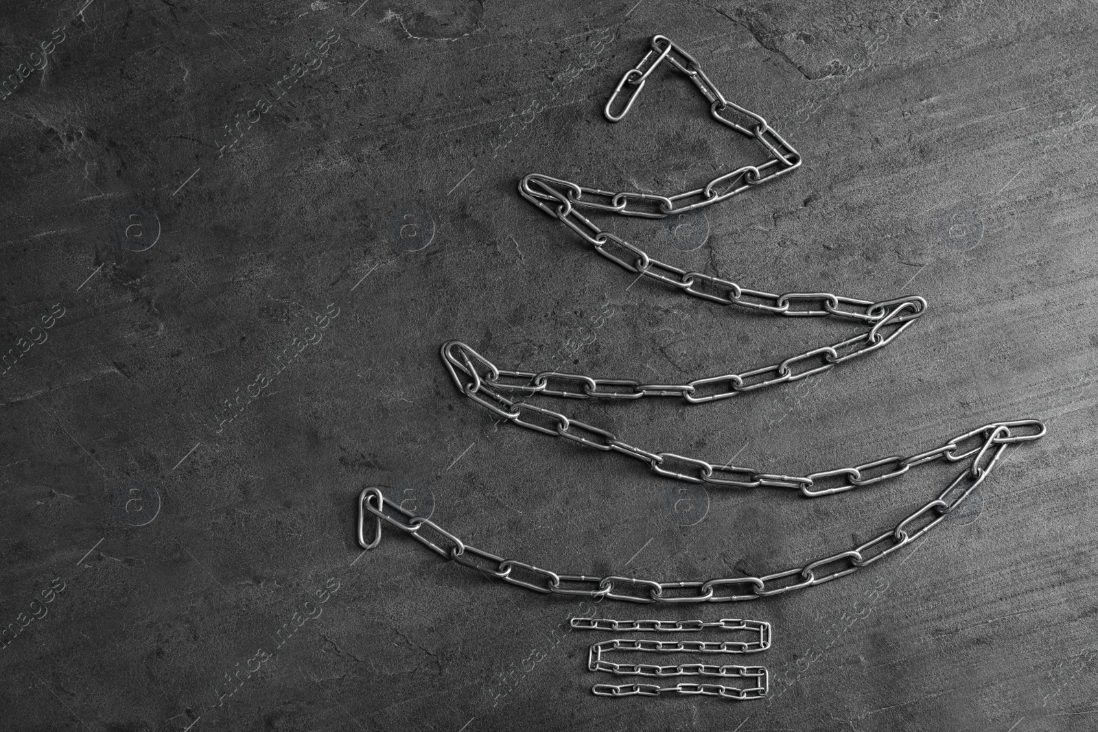 Photo of Flat lay composition with Christmas tree made of chains on grey table, space for text