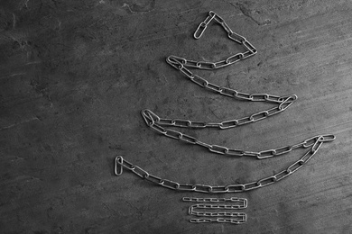 Photo of Flat lay composition with Christmas tree made of chains on grey table, space for text