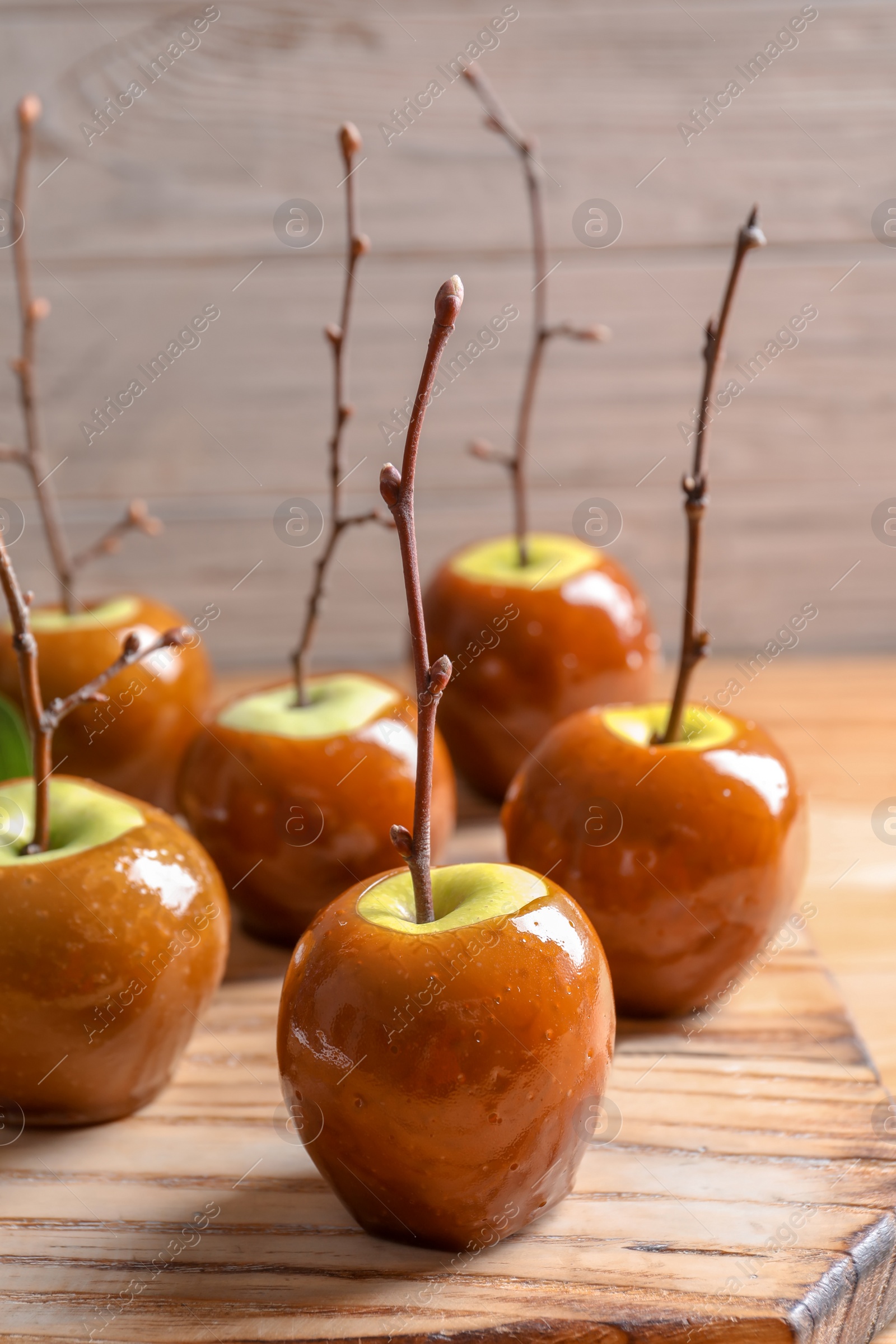 Photo of Delicious green caramel apples on table