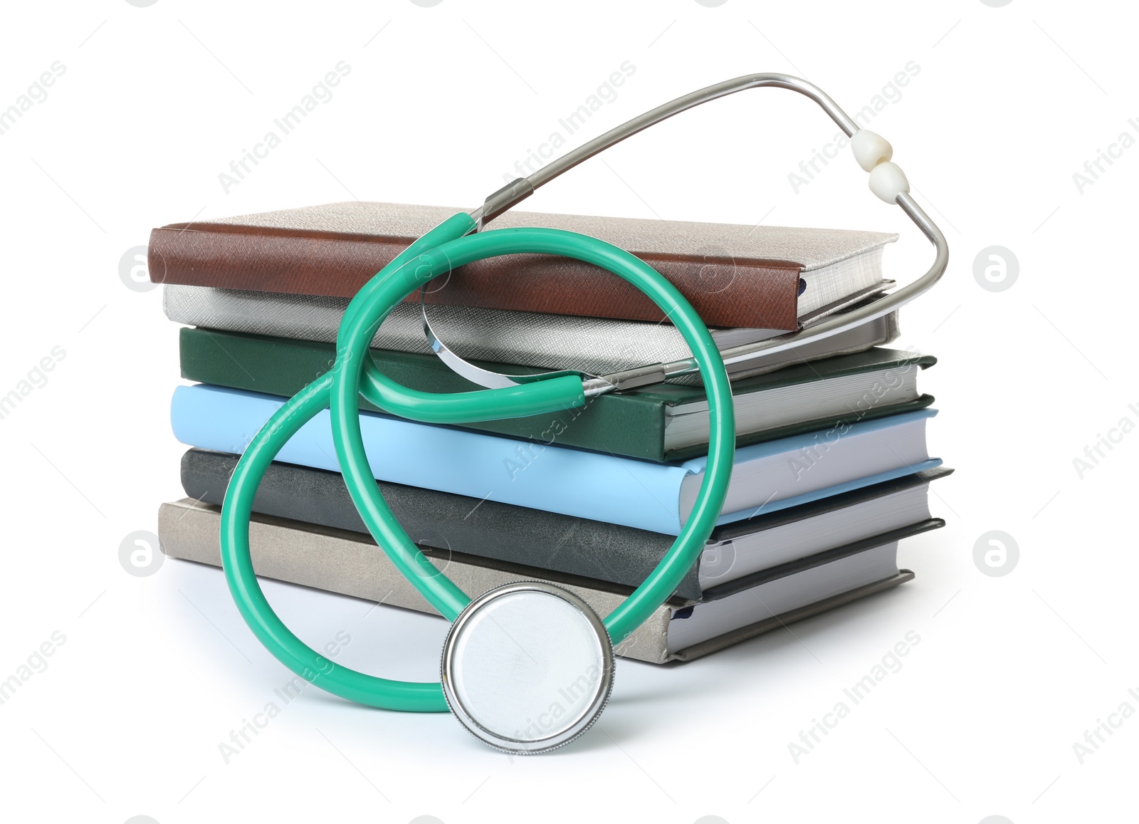 Photo of Stack of student textbooks and stethoscope on white background. Medical education