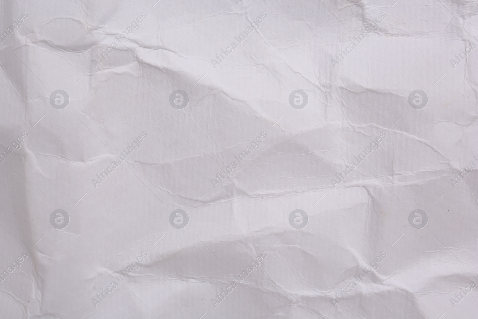 Photo of Texture of crumpled parchment paper as background, top view