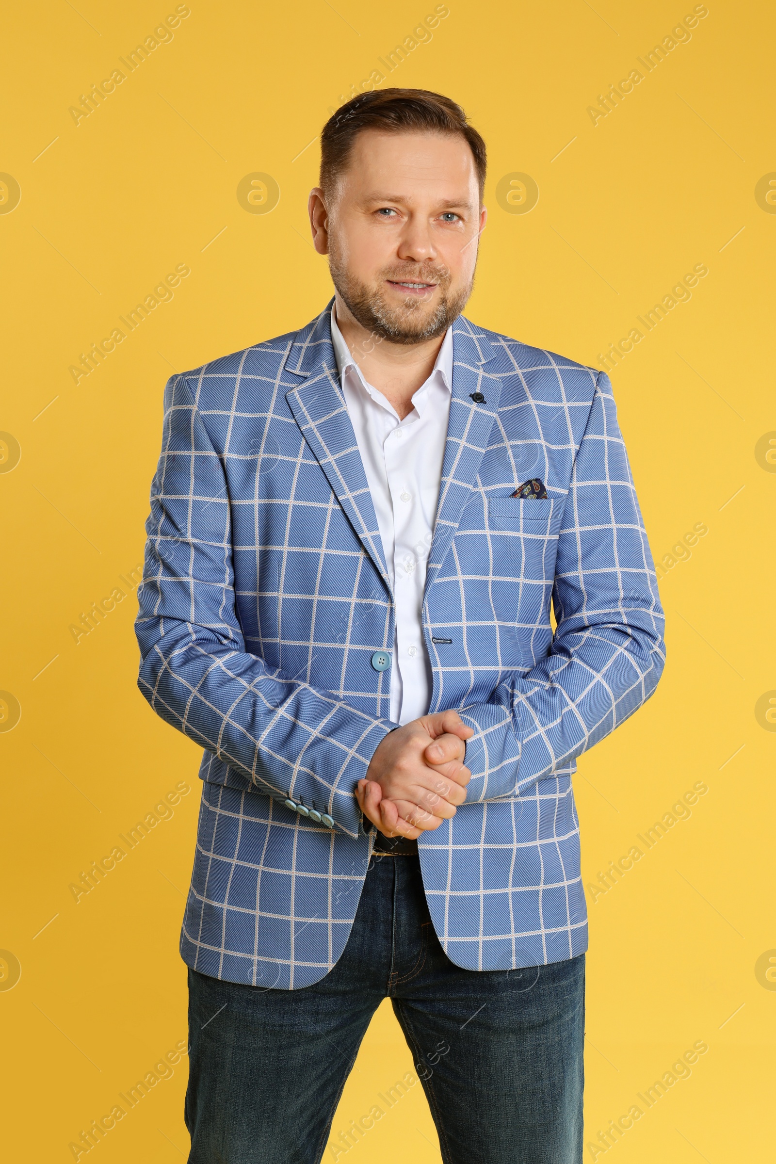 Photo of Portrait of happy mature man on yellow background