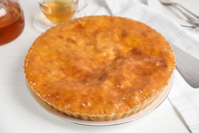 Photo of Delicious pie with meat on white wooden table
