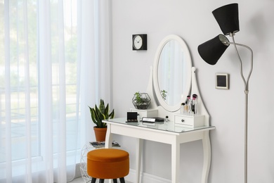 Photo of Dressing table with mirror in stylish room interior