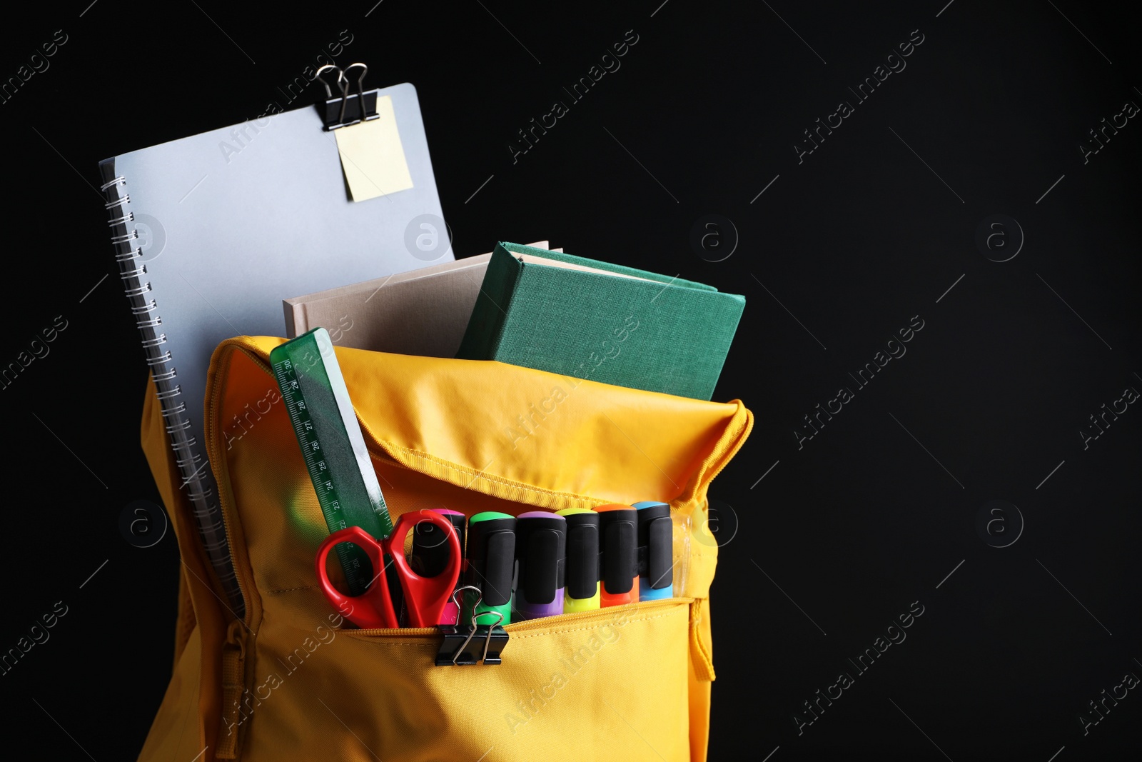 Photo of Backpack with different school stationery near blackboard, space for text