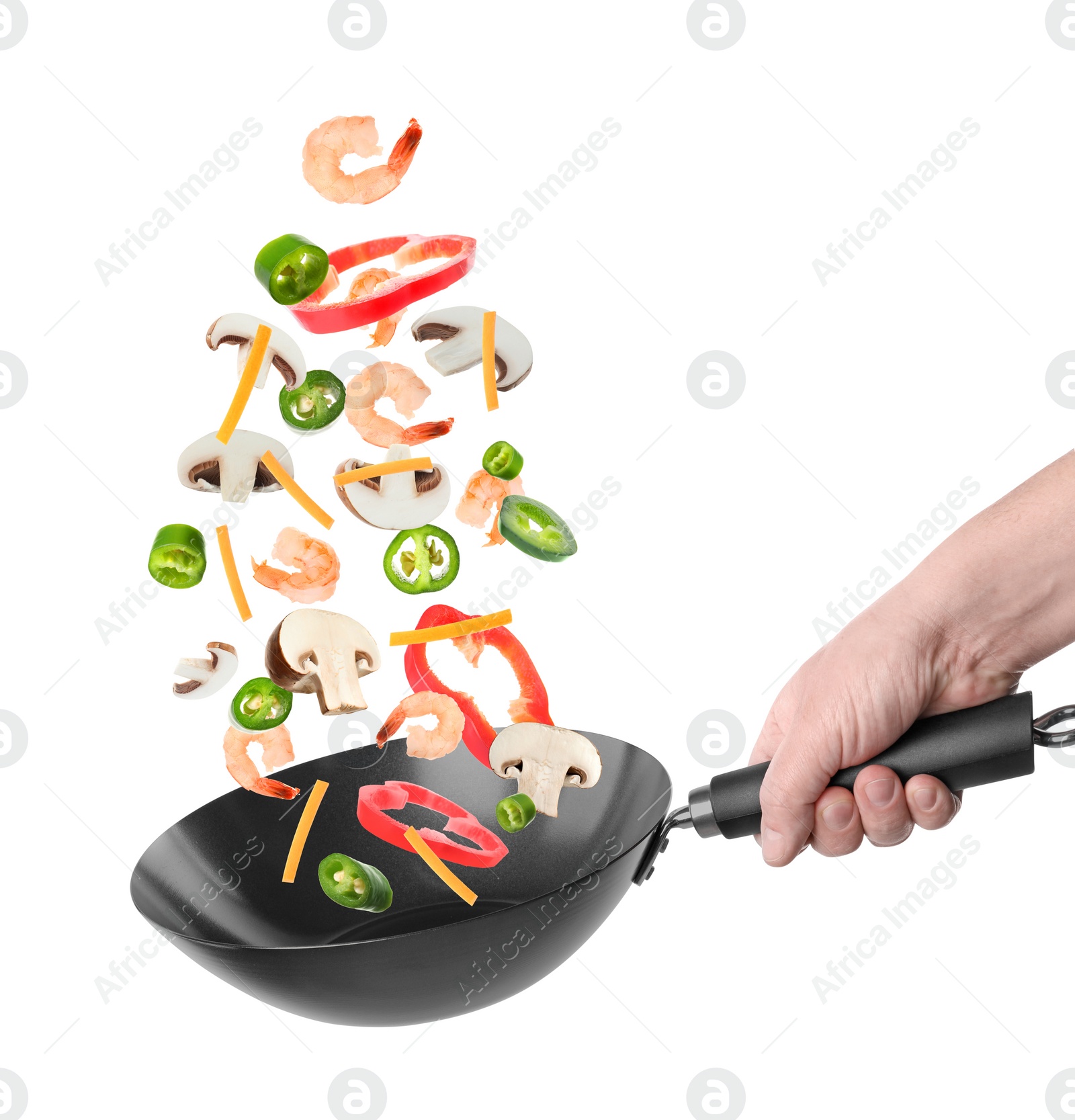 Image of Man tossing ingredients in wok on white background, closeup