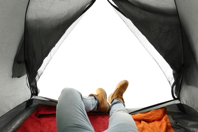 Photo of Closeup of man in camping tent on white background, view from inside