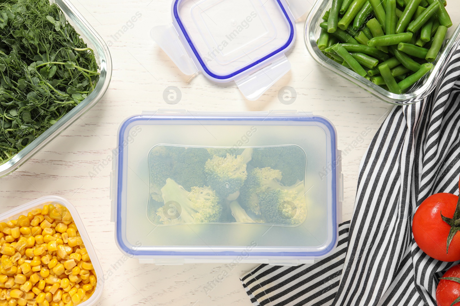 Photo of Containers with fresh products on white wooden table, flat lay. Food storage