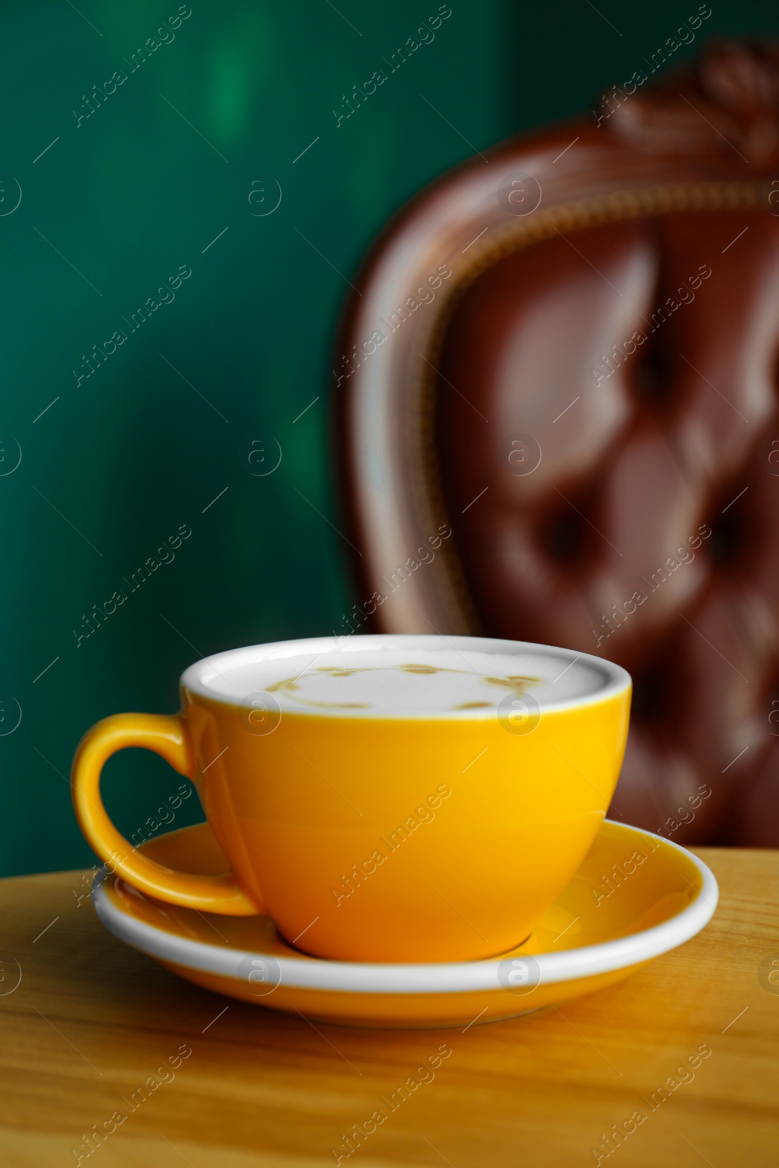 Photo of Cup of delicious coffee on wooden table indoors