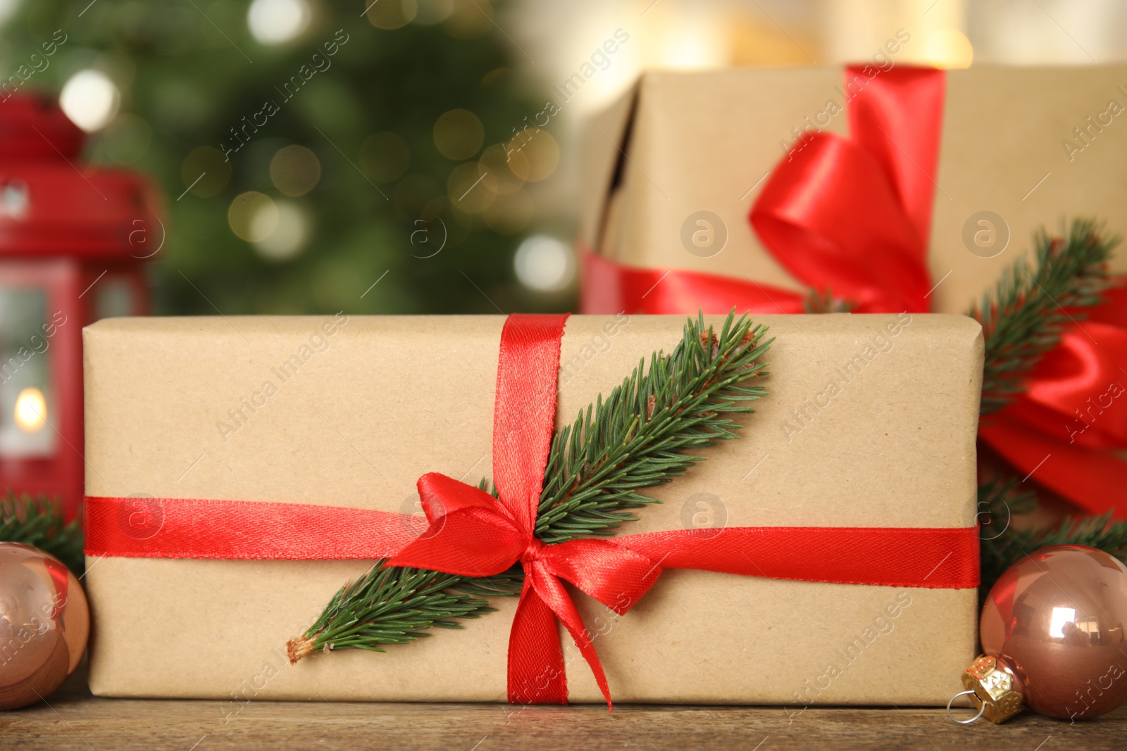 Photo of Beautiful gift boxes and Christmas decor on wooden table, closeup
