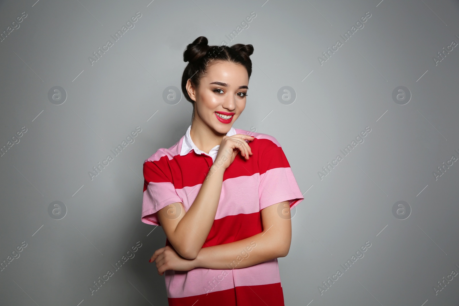 Photo of Portrait of beautiful young woman on grey background