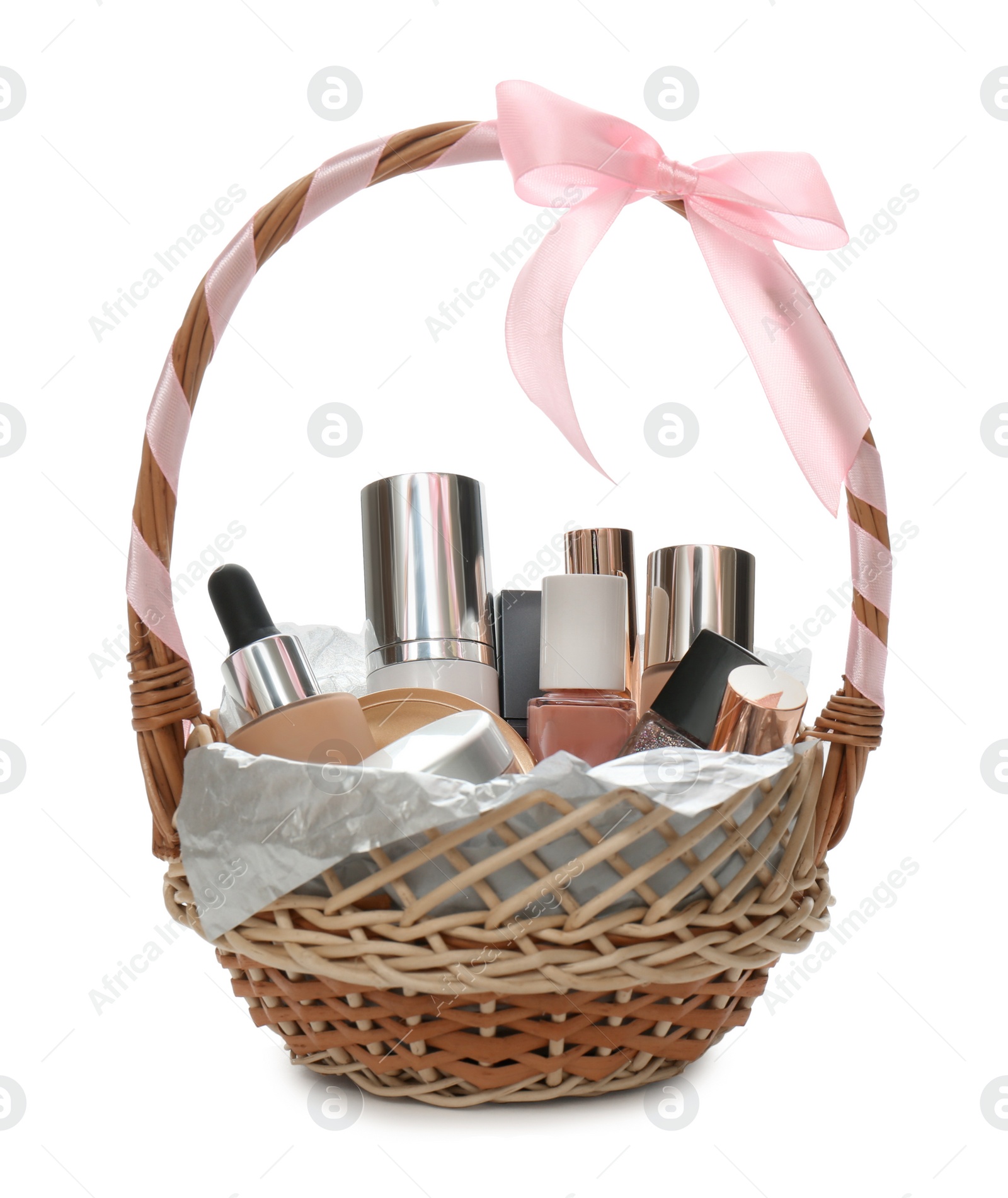 Photo of Cosmetic gift set in wicker basket isolated on white