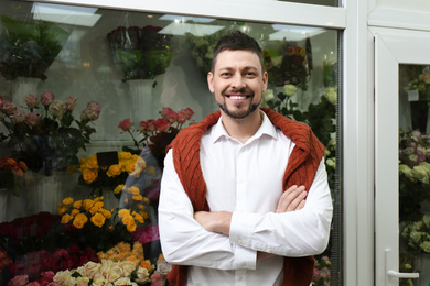 Photo of Male business owner standing in his flower shop