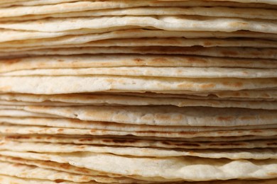 Photo of Stack of tasty tortillas as background, closeup